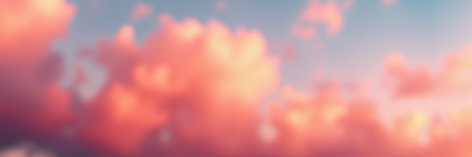 Colorful clouds illuminate the sky during sunset over a tranquil landscape